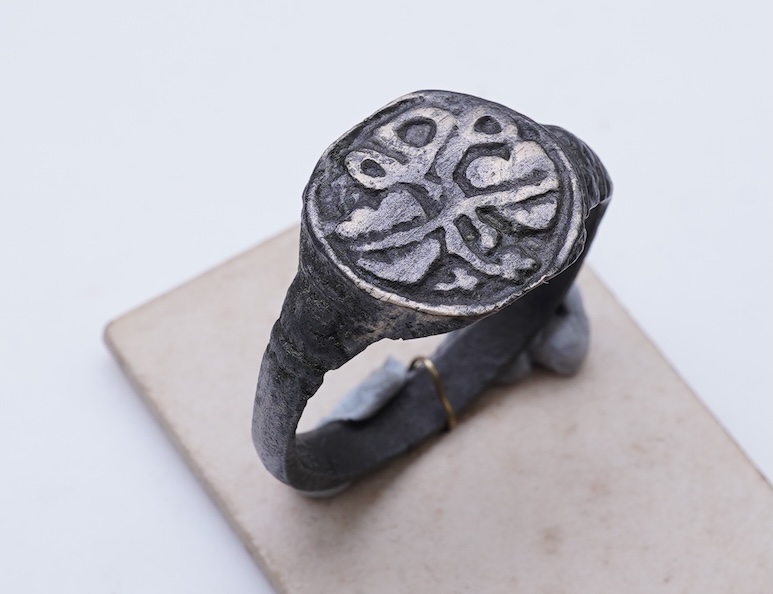 A sentimental signet ring, France, circa 16th century, the circular panel depicting two hearts tied in a true lover's knot, size R1/2, labelled 2244, Provenance: formerly in the collection of Dame Joan Evans (1893-1977)